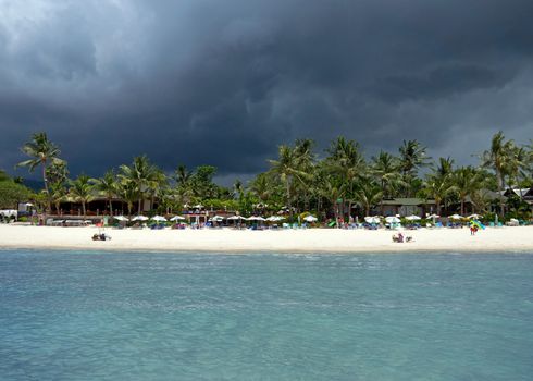 KOH SAMUI, THAILAND - JULY 30: View at the Chaweng Beach before storm on July 30, 2013 in Koh Samui, Thailand. People are sunbathing on the Chaweng beach in Koh Samui.

Koh Samui, Thailand - July 30, 2013: View at the Chaweng Beach before storm. People are sunbathing on the Chaweng beach in Koh Samui.