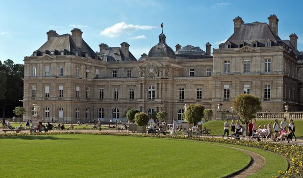 PARIS, FRANCE - JUNE 11, 2014: The Luxembourg Palace in The Jardin du Luxembourg. View on the main facade. Many people are resting there.

Paris, France - June 11, 2014: The Luxembourg Palace in The Jardin du Luxembourg. View on the main facade. Many people are resting there.