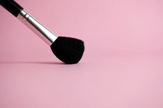 brush makeup tools with pink pastel background. Image photo