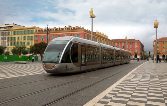 NICE, FRANCE - APRIL 27: Modern tram in the center of Nice, France on April 27, 2013. Central Square - Place Massena, new landmark of the town. It was reconstructed in 1979.

Nice, France - April 27, 2013: People traveling in tram in the centre of city. 
Modern tram in the center of Nice, France. People traveling in tram in the centre of city. 