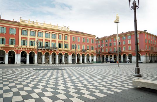 NICE, FRANCE - APRIL 27: The Place Massena on April 27, 2013 in Nice, France. The square was reconstructed in 1979.

Nice, France - April 27, 2013: Views of the Place Massena. Square is located in the city center and is the most popular destination among tourists. There are many boutiques, cafes and restaurants. People are walking thru scuare.