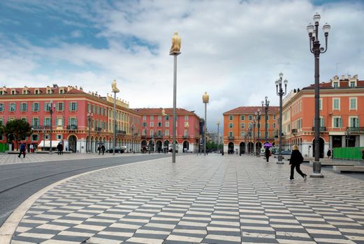 NICE, FRANCE - APRIL 27: The Place Massena on April 27, 2013 in Nice, France. The square was reconstructed in 1979.

Nice, France - April 27, 2013: Views of the Place Massena. Square is located in the city center and is the most popular destination among tourists. There are many boutiques, cafes and restaurants. People are walking thru scuare.