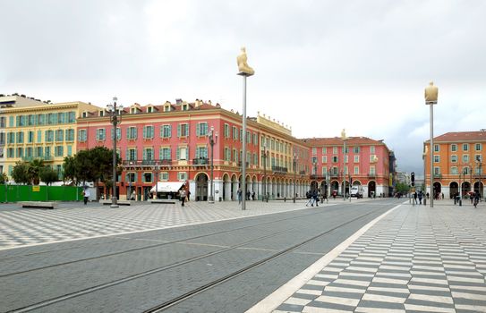 NICE, FRANCE - APRIL 27: The Place Massena on April 27, 2013 in Nice, France. The square was reconstructed in 1979.

Nice, France - April 27, 2013: Views of the Place Massena. Square is located in the city center and is the most popular destination among tourists. There are many boutiques, cafes and restaurants. People are walking thru scuare.