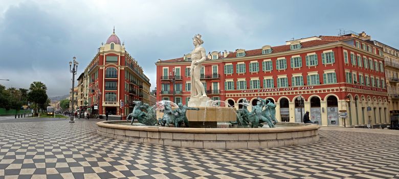 NICE, FRANCE - APRIL 27: View to Place Massena and fountain Soleil on April 27, 2013 in Nice, France. The square was reconstructed in 1979.

Nice, France - April 27, 2013: View to Place Massena and fountain Soleil. Square is located in the city center and is the most popular destination among tourists. The square was reconstructed in 1979. There are many boutiques, cafes and restaurants. People are walking and resting there.