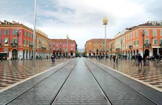 NICE, FRANCE - APRIL 26: The Place Massena on April 26, 2013 in Nice, France. The square was reconstructed in 1979.

Nice, France - April 26, 2013: Views of the Place Massena. Square is located in the city center and is the most popular destination among tourists. There are many boutiques, cafes and restaurants. People are walking.