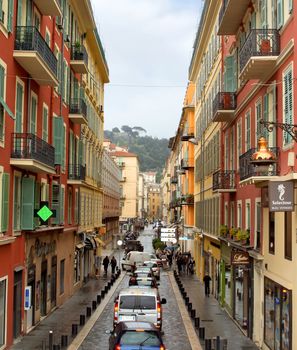 NICE, FRANCE - APRIL 27: The architecture of buildings on the Place Massena on April 27, 2013 in Nice, France. The square is bordered by red ochre buildings of Italian architecture.