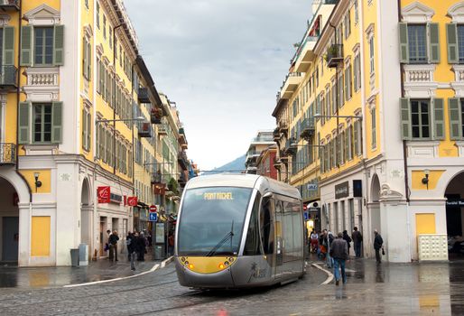 NICE, FRANCE - APRIL 26: Modern tram in the center of Nice, France on April 26, 2013. Old Square - Place Garibaldi. The square was built in 1870.

Nice, France - April 26, 2013: Modern tram in the center of city. People are walking along street.