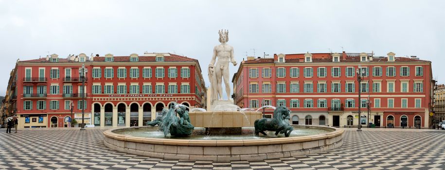 NICE, FRANCE - APRIL 27: Panoramic view to Place Massena and fountain Soleil on April 27, 2013 in Nice, France. The square was reconstructed in 1979.

Nice, France - April 27, 2013: Panoramic view to Place Massena and fountain Soleil. Square is located in the city center and is the most popular destination among tourists. There are many boutiques, cafes and restaurants. People are walking and resting there.