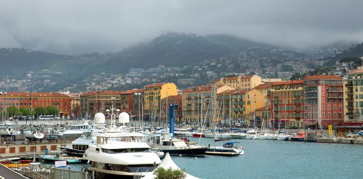 NICE, FRANCE - APRIL 27: Colorful buildings and boats within a Port de Nice on April 27, 2013 in Nice, France. Port de Nice was started in 1745.

Nice, France - April 27, 2013 : Colorful buildings and boats within a Port de Nice in French Riviera. Port de Nice was started in 1745.
Colorful buildings and boats within a harbor in beautiful Villefranche, France