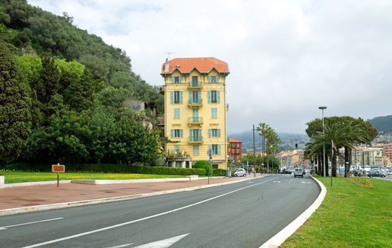 NICE, FRANCE - APRIL 27: Architecture along Promenade des Anglais on April 27, 2013 in Nice, France. It is a symbol of the Cote d'Azur and was built in 1830 at the expense of the British colony.

Nice, France - April 27, 2013: Architecture along Promenade des Anglais. People are walking. Promenade des Anglais is a symbol of the Cote d'Azur and was built in 1830 at the expense of the British colony.