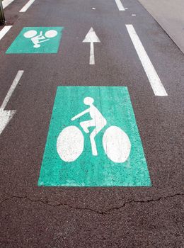 Green bicycle sign on the asphalt road