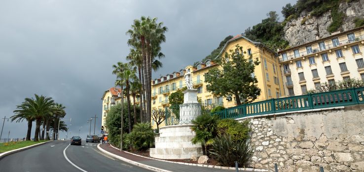 NICE, FRANCE - APRIL 27: Architecture along Promenade des Anglais on April 27, 2013 in Nice, France. It is a symbol of the Cote d'Azur and was built in 1830 at the expense of the British colony.

Nice, France - April 27, 2013: Architecture along Promenade des Anglais. People are walking. Promenade des Anglais is a symbol of the Cote d'Azur and was built in 1830 at the expense of the British colony.