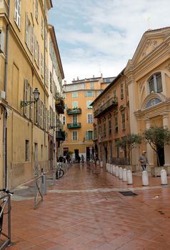 NICE, FRANCE - APRIL 27: Architecture of old town on April 27, 2013 in Nice, France. 

Nice, France - April 27, 2013: Architecture of old town.
People are walking along at the street in old town. 
