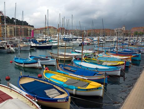NICE, FRANCE - APRIL 27: Colorful buildings and boats within a Port de Nice on April 27, 2013 in Nice, France. Port de Nice was started in 1745.

Nice, France - April 27, 2013 : Colorful buildings and boats within a Port de Nice in French Riviera. Port de Nice was started in 1745.