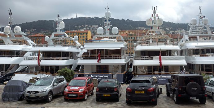 NICE, FRANCE - APRIL 27: Expensive yachts anchored within a Port de Nice on April 27, 2013 in Nice, France. Port de Nice was started in 1745.

Nice, France - April 27, 2013: Expensive yachts anchored within a Port de Nice in French Riviera. Port de Nice was started in 1745.