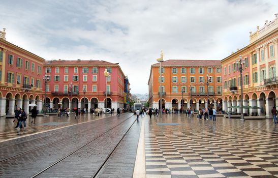 NICE, FRANCE - APRIL 26: The Place Massena on April 26, 2013 in Nice, France. Square is located in the city center and is the most popular destination among tourists. It was reconstructed in 1979.

Nice, France - April 26, 2013: People walking in central square - Place Massena, new landmark of the town.
Place Massena in Nice, France