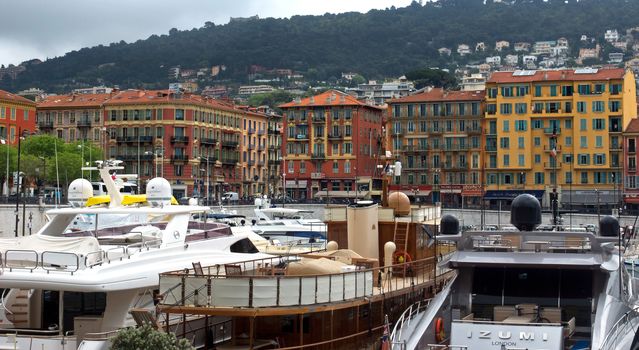 NICE, FRANCE - APRIL 27: Colorful buildings and boats within a Port de Nice on April 27, 2013 in Nice, France. Port de Nice was started in 1745.

Nice, France - April 27, 2013: Colorful buildings and boats within a Port de Nice in French Riviera. Port de Nice was started in 1745.