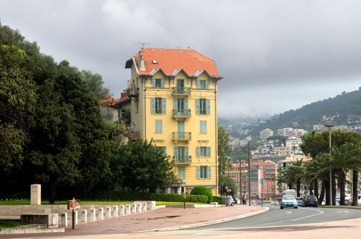 NICE, FRANCE - APRIL 27: Architecture along Promenade des Anglais on April 27, 2013 in Nice, France. It is a symbol of the Cote d'Azur and was built in 1830 at the expense of the British colony.

Nice, France - April 27, 2013: Architecture along Promenade des Anglais. People are walking. Promenade des Anglais is a symbol of the Cote d'Azur and was built in 1830 at the expense of the British colony.