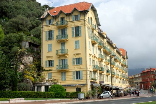 NICE, FRANCE - APRIL 27: Architecture along Promenade des Anglais on April 27, 2013 in Nice, France. It is a symbol of the Cote d'Azur and was built in 1830 at the expense of the British colony.

Nice, France - April 27, 2013: Architecture along Promenade des Anglais. People are walking. Promenade des Anglais is a symbol of the Cote d'Azur and was built in 1830 at the expense of the British colony.