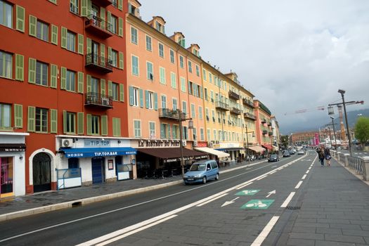 NICE, FRANCE - APRIL 27: Architecture along Promenade des Anglais on April 27, 2013 in Nice, France. It is a symbol of the Cote d'Azur and was built in 1830 at the expense of the British colony.

Nice, France - April 27, 2013: Architecture along Promenade des Anglais. People are walking. Promenade des Anglais is a symbol of the Cote d'Azur and was built in 1830 at the expense of the British colony.