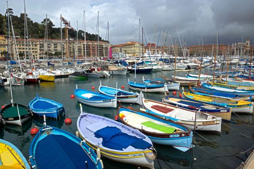 NICE, FRANCE - APRIL 27: Colorful buildings and boats within a Port de Nice on April 27, 2013 in Nice, France. Port de Nice was started in 1745.

Nice, France - April 27, 2013: Colorful buildings and boats within a Port de Nice in French Riviera. Port de Nice was started in 1745.
