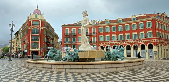 NICE, FRANCE - APRIL 27: View to Place Massena and fountain Soleil on April 27, 2013 in Nice, France. The square was reconstructed in 1979.

Nice, France - April 27, 2013: View to Place Massena and fountain Soleil. Square is located in the city center and is the most popular destination among tourists. The square was reconstructed in 1979. There are many boutiques, cafes and restaurants. People are walking and resting there.