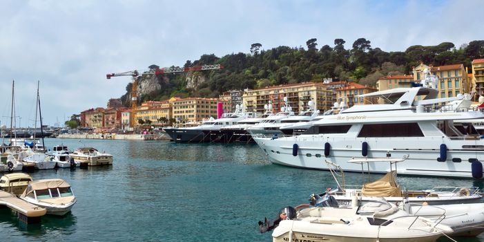 NICE, FRANCE - APRIL 27: Buildings and boats within a Port de Nice on April 27, 2013 in Nice, France. Port de Nice was started in 1745.

Nice, France - April 27, 2013: Buildings and boats within a Port de Nice in French Riviera. Port de Nice was started in 1745.