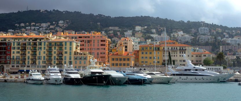 NICE, FRANCE - APRIL 27: Colorful buildings and boats within a Port de Nice on April 27, 2013 in Nice, France. Port de Nice was started in 1745.

Nice, France - April 27, 2013: Colorful buildings and boats within a Port de Nice in French Riviera. Port de Nice was started in 1745.