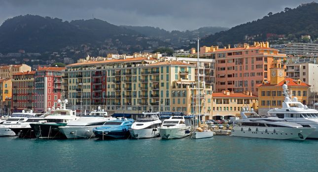 NICE, FRANCE - APRIL 27: Colorful buildings and boats within a Port de Nice on April 27, 2013 in Nice, France. Port de Nice was started in 1745.

Nice, France - April 27, 2013: Colorful buildings and boats within a Port de Nice in French Riviera. Port de Nice was started in 1745.