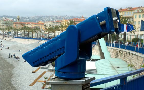 Blue binoculars to view Mediterranean Sea from Promenade des Anglais, Nice, France.