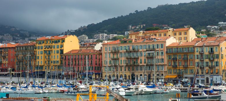 NICE, FRANCE - APRIL 27: Colorful buildings and boats within a Port de Nice on April 27, 2013 in Nice, France. Port de Nice was started in 1745.

Nice, France - April 27, 2013 : Colorful buildings and boats within a Port de Nice in French Riviera. Port de Nice was started in 1745.
Colorful buildings and boats within a harbor in beautiful Villefranche, France