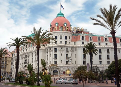 NICE, FRANCE - APRIL 27: Luxury Hotel Negresco on April 27, 2013 in Nice, France. Hotel Negresco is the famous luxury hotel on the Promenade des Anglais in Nice, a symbol of the Cote d'Azur.

Nice, France - April 27, 2013: Luxury Hotel Negresco on English Promenade in Nice, French Riviera. Hotel Negresco is the famous luxury hotel on the Promenade des Anglais in Nice, a symbol of the Cote d'Azur. People are walking.