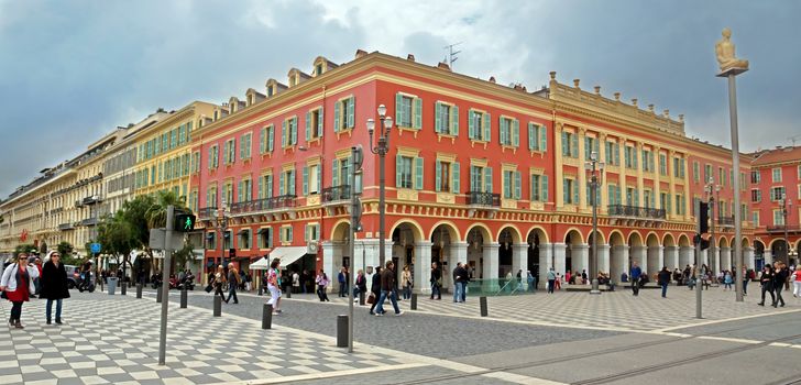 NICE, FRANCE - APRIL 27: The Place Massena on April 27, 2013 in Nice, France. The square was reconstructed in 1979.

Nice, France - April 27, 2013: Views of the Place Massena. Square is located in the city center and is the most popular destination among tourists. There are many boutiques, cafes and restaurants. People are walking thru scuare.