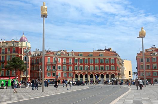 NICE, FRANCE - APRIL 27: The Place Massena on April 27, 2013 in Nice, France. The square was reconstructed in 1979.

Nice, France - April 27, 2013: Views of the Place Massena. Square is located in the city center and is the most popular destination among tourists. There are many boutiques, cafes and restaurants. People are walking thru scuare.