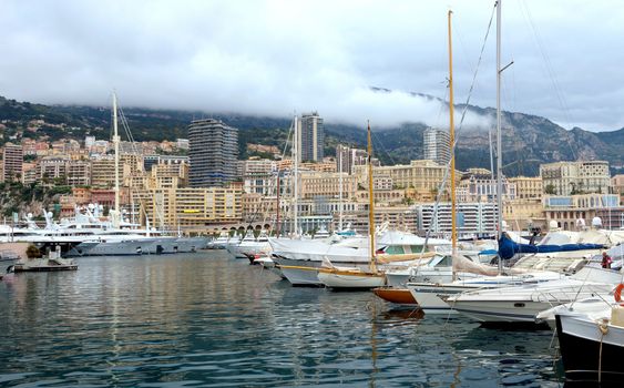 MONTE CARLO, MONACO - APRIL 28: Fashionable yachts in the port Hercules and view on the city on April 28, 2013 in Monte Carlo, Monaco.

Monte Carlo, Monaco - April 28, 2013: Fashionable yachts in the port Hercules and view on the city.