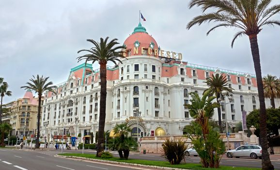 NICE, FRANCE - APRIL 27: Luxury Hotel Negresco on April 27, 2013 in Nice, France. Hotel Negresco is the famous luxury hotel on the Promenade des Anglais in Nice, a symbol of the Cote d'Azur.

Nice, France - April 27, 2013: Luxury Hotel Negresco on English Promenade in Nice, French Riviera. Hotel Negresco is the famous luxury hotel on the Promenade des Anglais in Nice, a symbol of the Cote d'Azur.