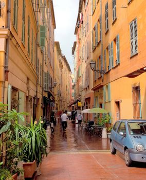 NICE, FRANCE - APRIL 29: Architecture of city of Nice in the old town on April 29, 2013 in Nice, France.

Nice, France - April 29, 2013: Architecture of city of Nice in the old town. People walk by street.