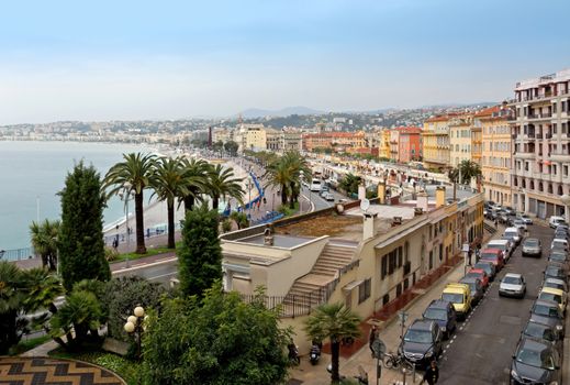 NICE, FRANCE - APRIL 29: Architecture along Promenade des Anglais on April 29, 2013 in Nice, France. It is a symbol of the Cote d'Azur and was built in 1830 at the expense of the British colony.

Nice, France - April 29, 2013: Architecture along Promenade des Anglais. People are resting. Promenade des Anglais is a symbol of the Cote d'Azur and was built in 1830 at the expense of the British colony.