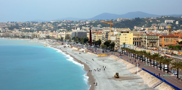 NICE, FRANCE - APRIL 29: Architecture along Promenade des Anglais on April 29, 2013 in Nice, France. It is a symbol of the Cote d'Azur and was built in 1830 at the expense of the British colony.

Nice, France - April 29, 2013: Architecture along Promenade des Anglais. People are resting. Promenade des Anglais is a symbol of the Cote d'Azur and was built in 1830 at the expense of the British colony.