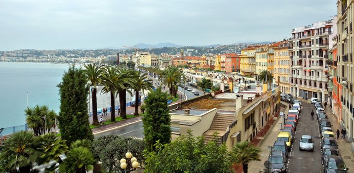 NICE, FRANCE - APRIL 29: Architecture along Promenade des Anglais on April 29, 2013 in Nice, France. It is a symbol of the Cote d'Azur and was built in 1830 at the expense of the British colony.

Nice, France - April 29, 2013: Architecture along Promenade des Anglais. People are resting. Promenade des Anglais is a symbol of the Cote d'Azur and was built in 1830 at the expense of the British colony. People are walking by street.