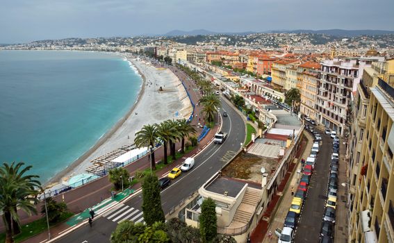 NICE, FRANCE - APRIL 29: Architecture along Promenade des Anglais on April 29, 2013 in Nice, France. It is a symbol of the Cote d'Azur and was built in 1830 at the expense of the British colony.

Nice, France - April 29, 2013: Architecture along Promenade des Anglais. Promenade des Anglais is a symbol of the Cote d'Azur and was built in 1830 at the expense of the British colony. People are walking by street.