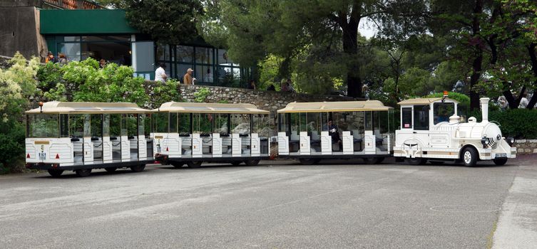 NICE, FRANCE - APRIL 29: White trackless train for sightseeing on the Promenade des Anglais on April 29, 2013 in Nice, France. Passengers left the train for sightseeing.

Nice, France - April 29, 2013 : White trackless train for sightseeing on the Promenade des Anglais in Nice. Passengers left the train for sightseeing.