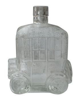 Old bottle in the form of a car isolated on white. Clipping path included.