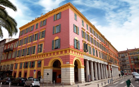 NICE, FRANCE - APRIL 30: The architecture of buildings on the Place Massena on April 30, 2013 in Nice, France. The square is bordered by red ochre buildings of Italian architecture.

Nice, France - April 30, 2013: The architecture of buildings on the Place Massena. The square is bordered by red ochre buildings of Italian architecture.