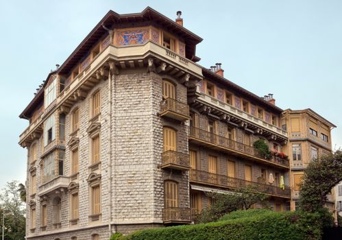 NICE, FRANCE - APRIL 29: Architecture along Promenade des Anglais on April 29, 2013 in Nice, France. It is a symbol of the Cote d'Azur and was built in 1830 at the expense of the British colony.

Nice, France - April 29, 2013: Architecture along Promenade des Anglais. People are resting. Promenade des Anglais is a symbol of the Cote d'Azur and was built in 1830 at the expense of the British colony.