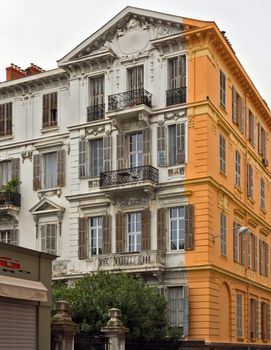 NICE, FRANCE - APRIL 29: Architecture along Promenade des Anglais on April 29, 2013 in Nice, France. It is a symbol of the Cote d'Azur and was built in 1830 at the expense of the British colony.

Nice, France - April 29, 2013: Architecture along Promenade des Anglais. People are resting. Promenade des Anglais is a symbol of the Cote d'Azur and was built in 1830 at the expense of the British colony.