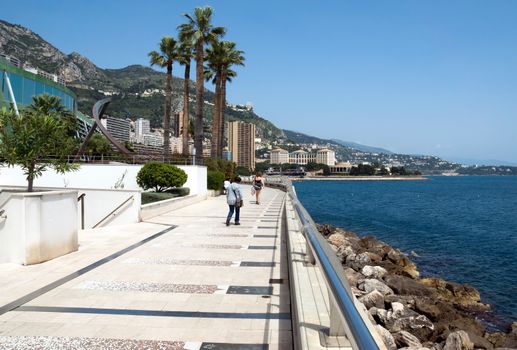 MONTE CARLO, MONACO - MAY 1: Larvotto Promenade on May 1, 2013 in Monte Carlo, Monaco. Larvotto is a part of the district of Monte Carlo in the Principality of Monaco.

Monte Carlo, Monaco - May 1, 2013: Larvotto Promenade. Larvotto is a part of the district of Monte Carlo in the Principality of Monaco. People walk along the waterfront.
