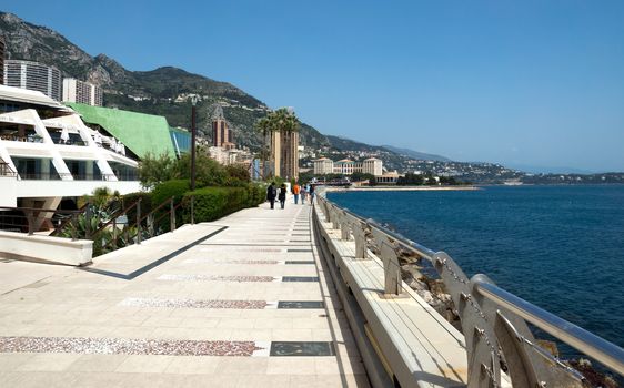 MONTE CARLO, MONACO - MAY 1: Larvotto Promenade on May 1, 2013 in Monte Carlo, Monaco. Larvotto is a part of the district of Monte Carlo in the Principality of Monaco.

Monte Carlo, Monaco - May 1, 2013: Larvotto Promenade. Larvotto is a part of the district of Monte Carlo in the Principality of Monaco. People walk along the waterfront.