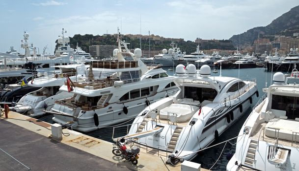 MONTE CARLO, MONACO - MAY 1: View on Port Hercules with luxurious yachts on May 1, 2013 in Monte Carlo, Monaco. It is the only deep-water port in Monaco. The port has been in use since ancient times.

Monte Carlo, Monaco - May 1, 2013: View on Port Hercules with luxurious yachts. It is the only deep-water port in Monaco. The port has been in use since ancient times.
