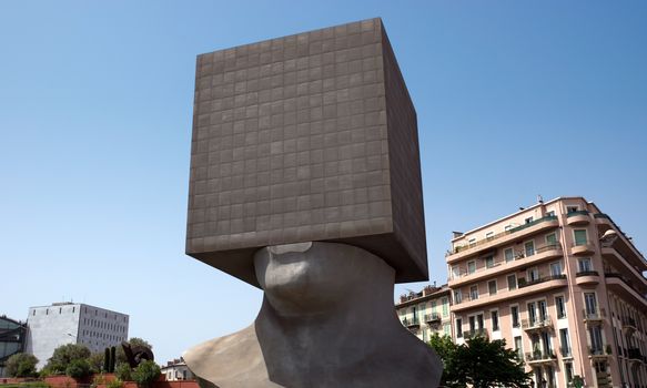 NICE, FRANCE - MAY 2: Square Head - building cube shaped as human head sculpture on May 2, 2013 in Nice, France. Authors are sculptor Sacha Sosno and architect Yves Bayard. Opened on June 29, 2002.

Nice, France - May 2, 2013: Square Head - building cube shaped as human head sculpture. Authors are sculptor Sacha Sosno and architect Yves Bayard. Opened on June 29, 2002.